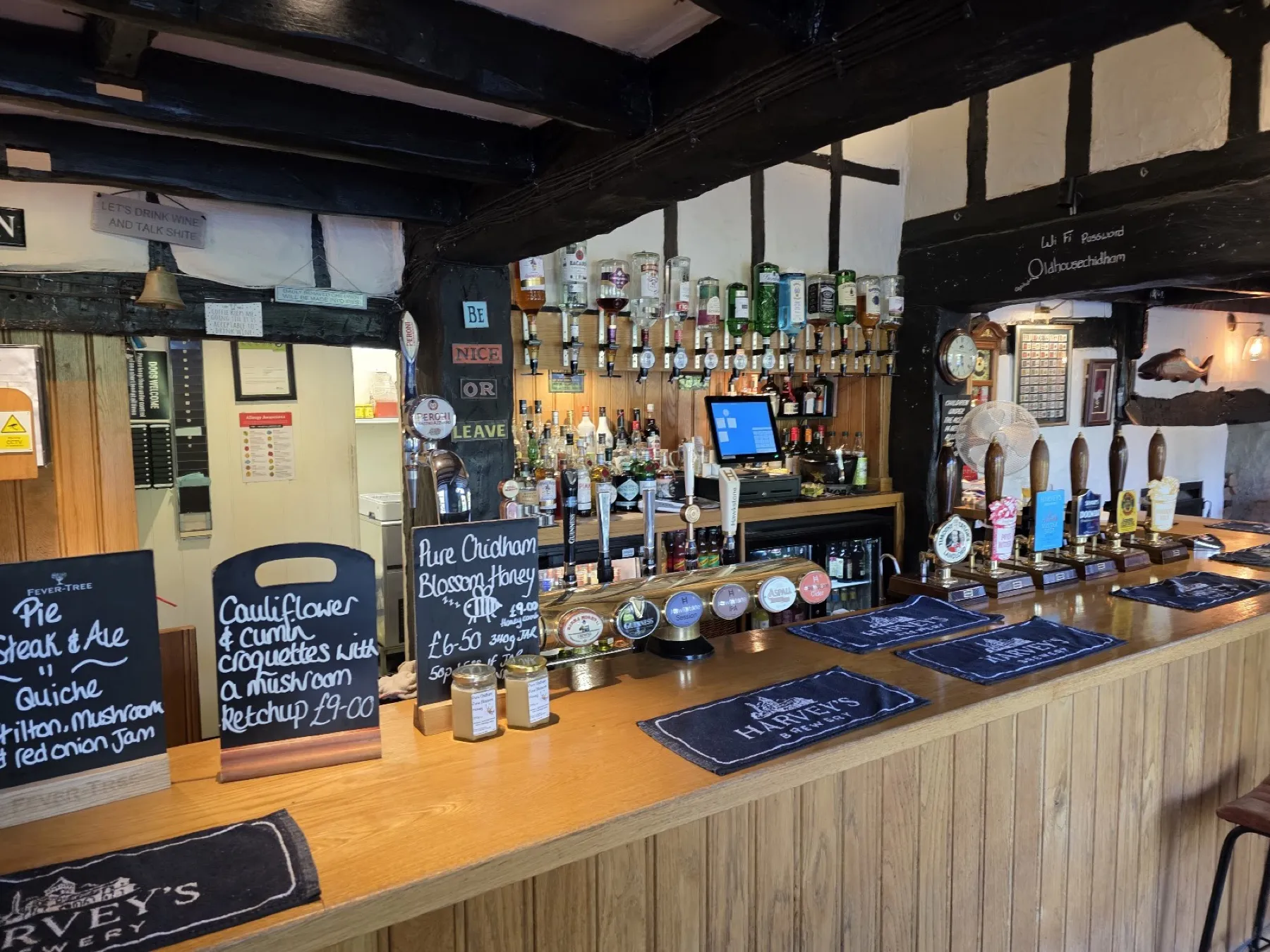 The bar at The Old House at Home, with hand pumps and chalkboard specials