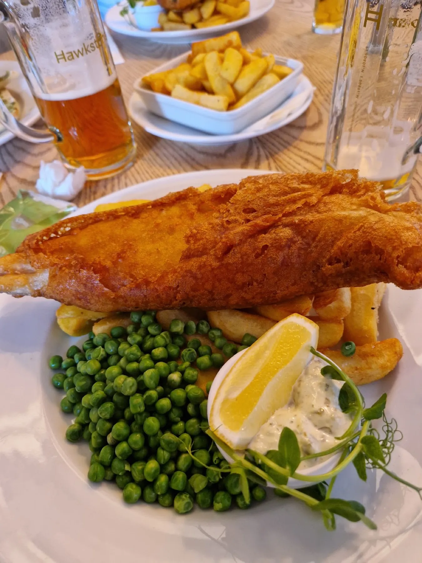 Beer battered fish and chips with peas and tartare sauce